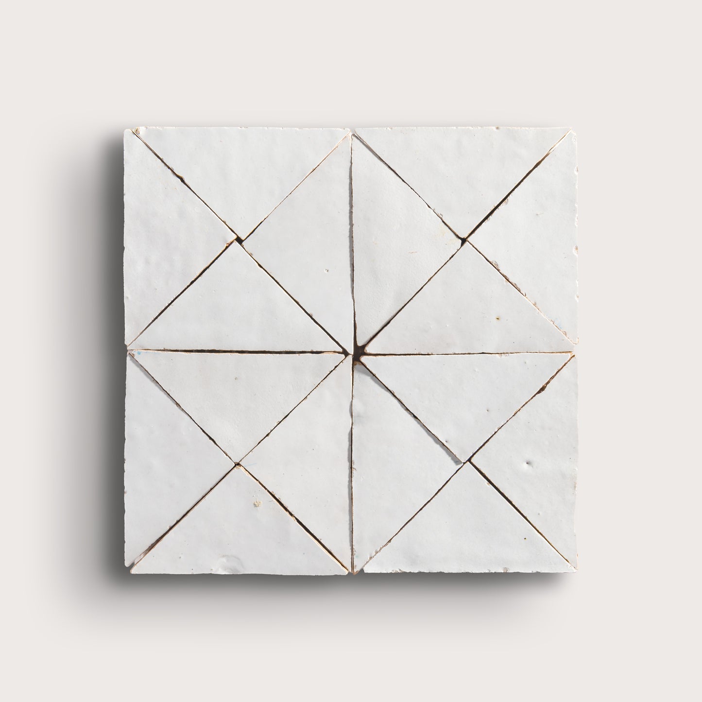 snow white mosaic traingle zellige tile on a light grey background