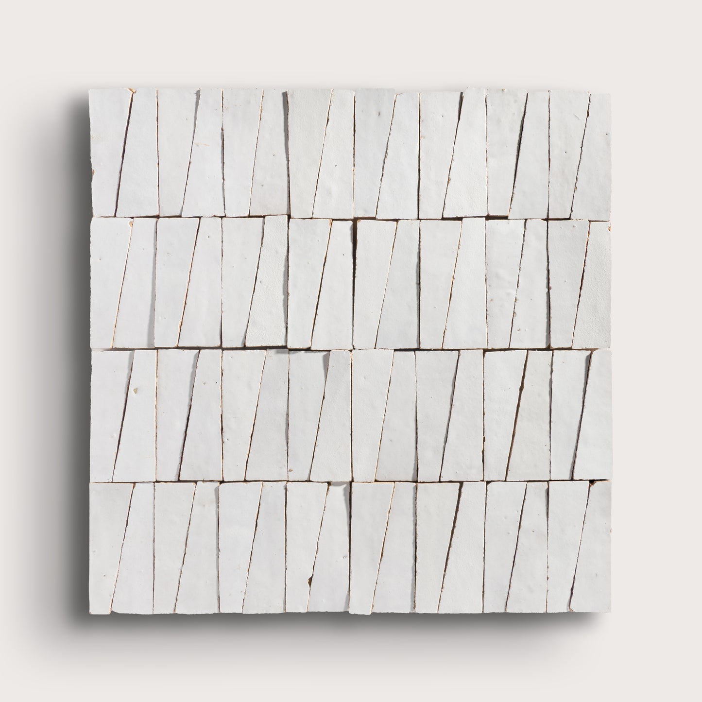 snow white trapezoid zellige tile on a light grey background