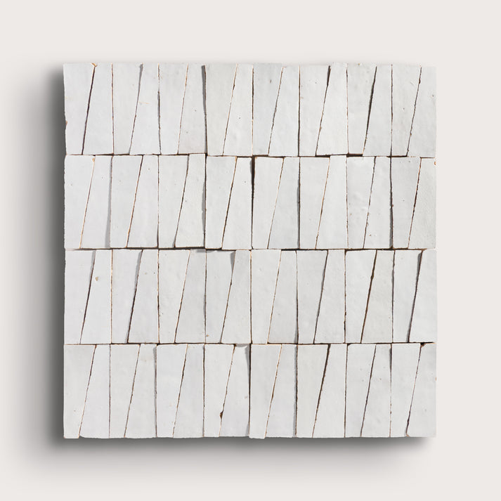 snow white trapezoid zellige tile on a light grey background