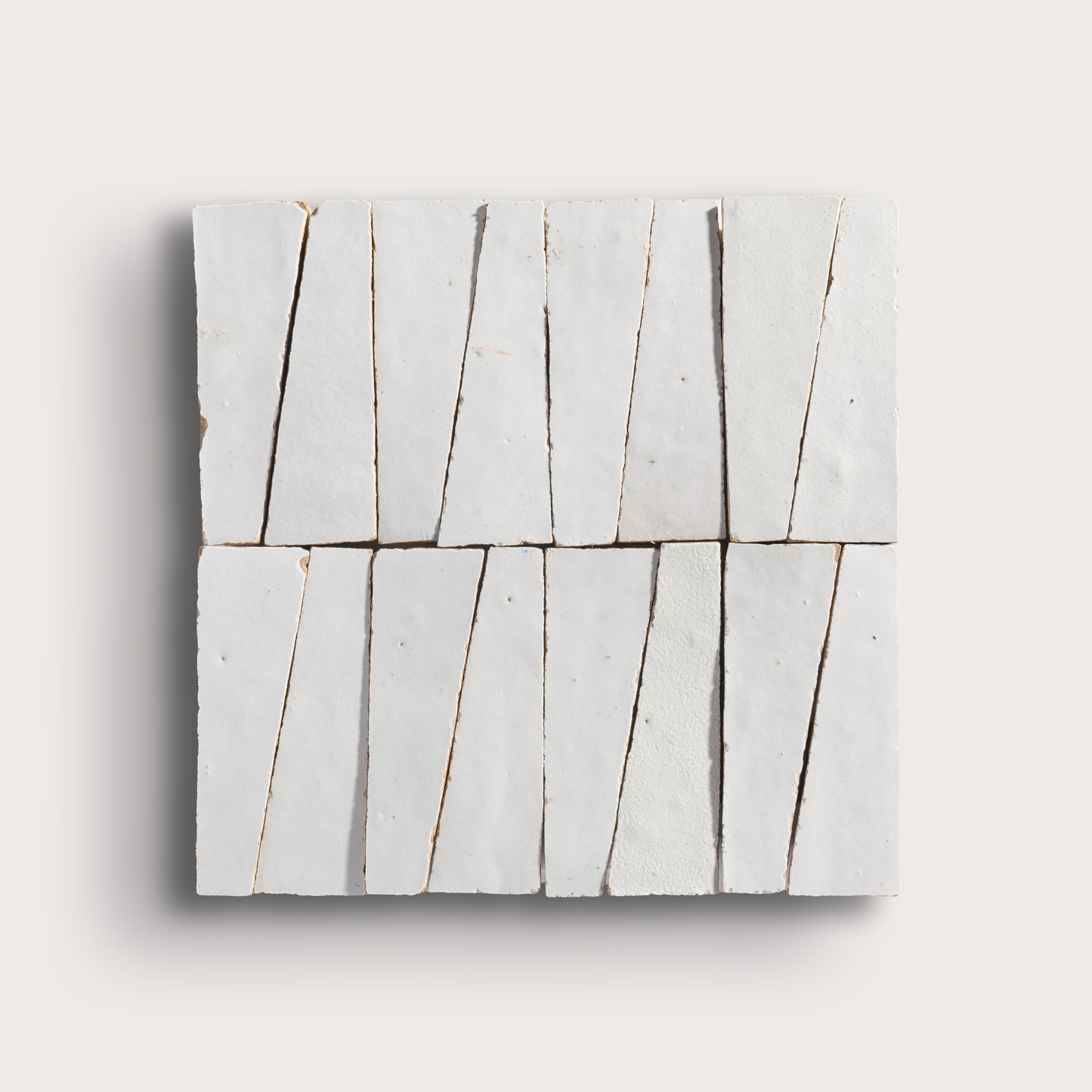 snow white trapezoid zellige tile on a light grey background