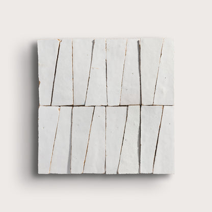 snow white trapezoid zellige tile on a light grey background