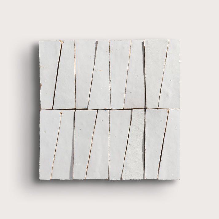 snow white trapezoid zellige tile on a light grey background