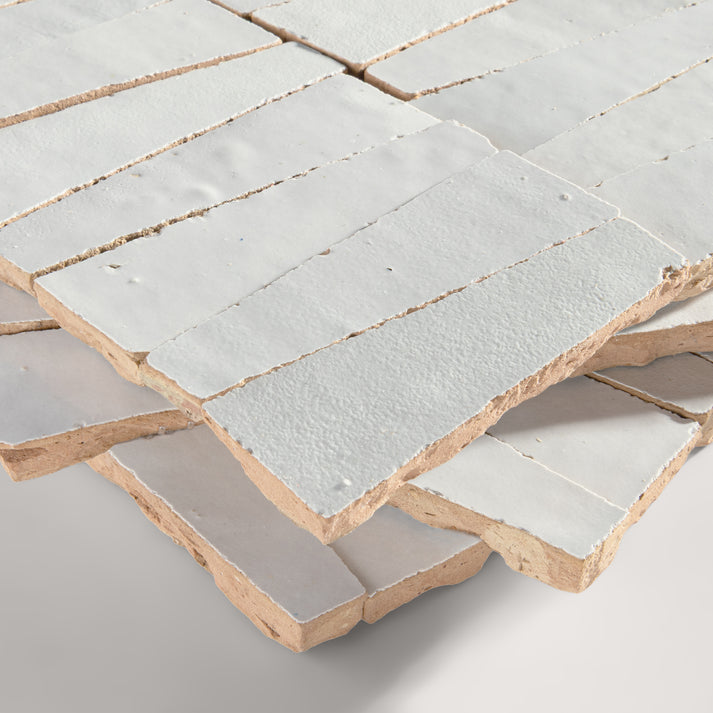 snow white trapezoid zellige tile on a light grey background