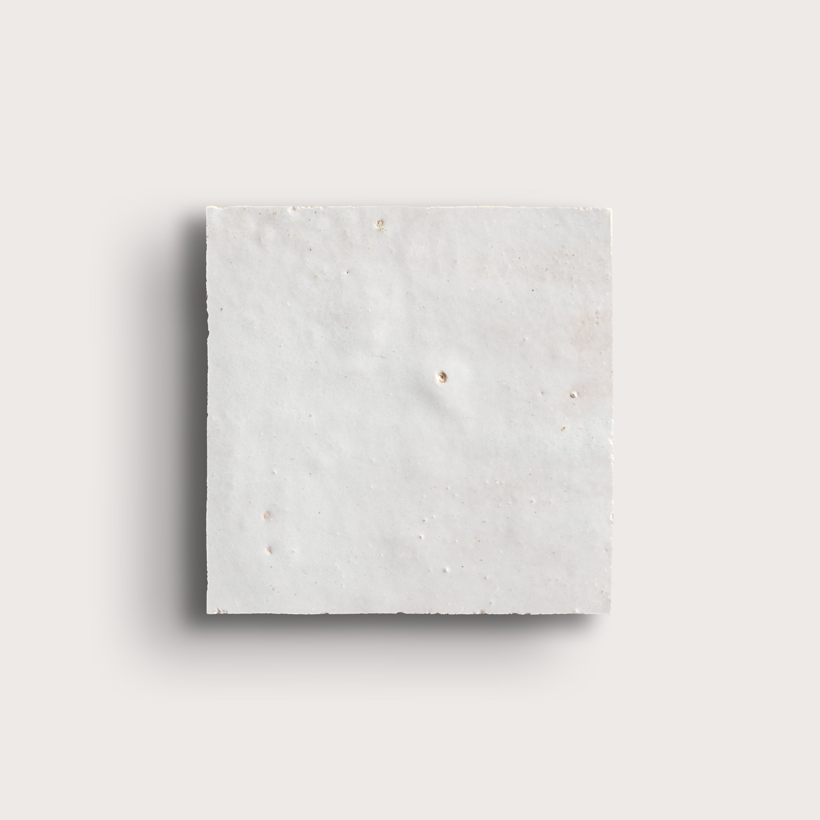 snow white square zellige tile on a light grey background