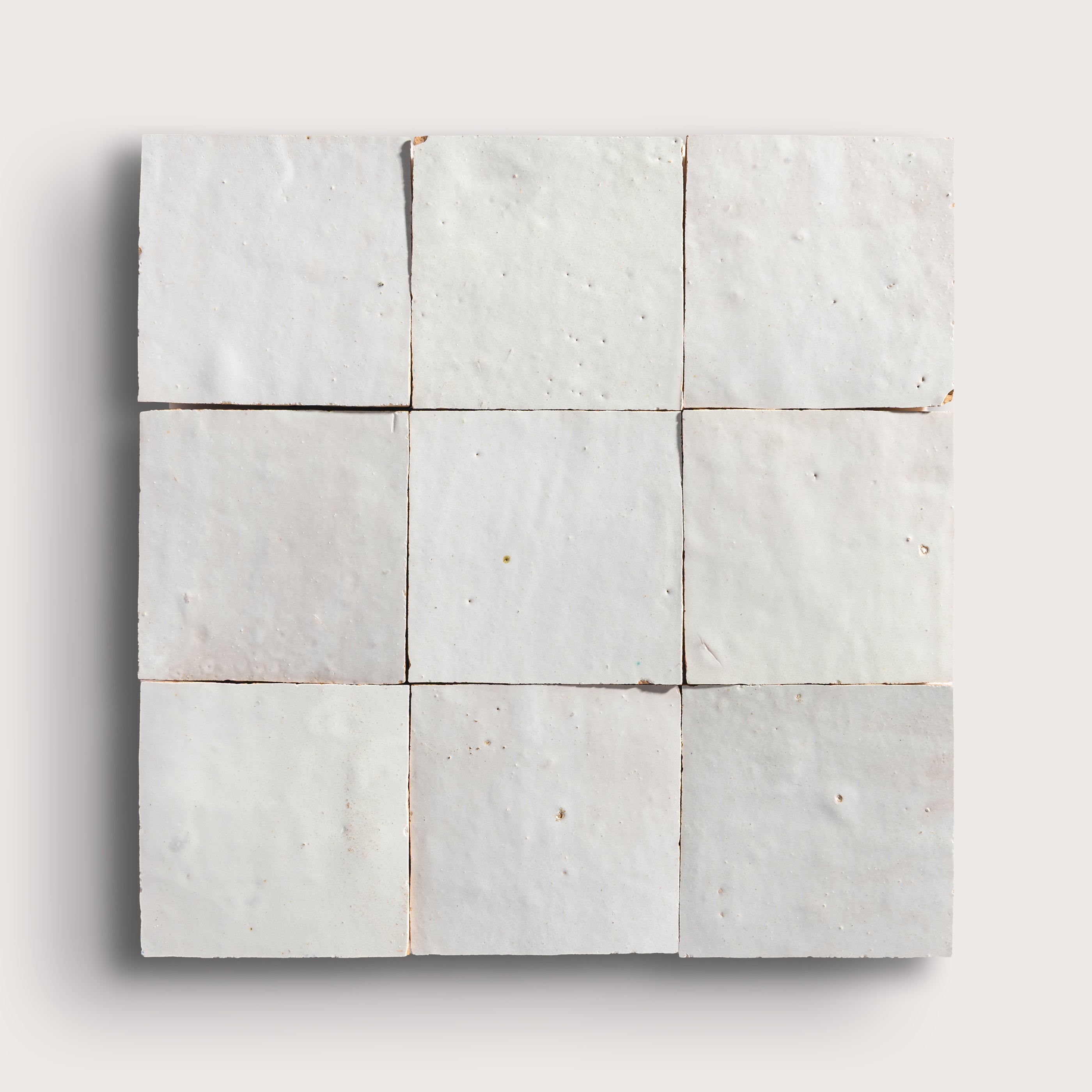 snow white square zellige tile on a light grey background
