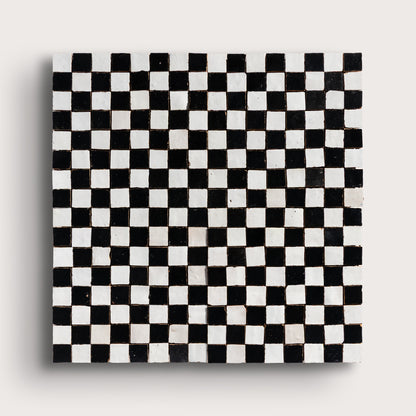 black and white small square checkerboard zellige tile on a light grey background