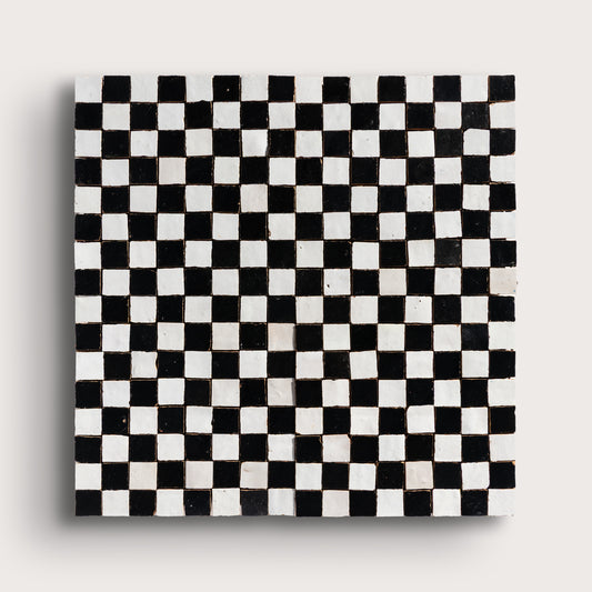 black and white small square checkerboard zellige tile on a light grey background