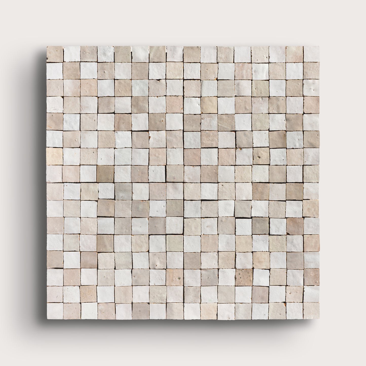 white small square checkerboard zellige tile on a light grey background