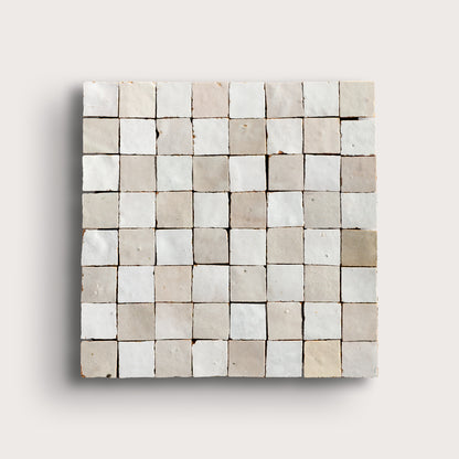 white small square checkerboard zellige tile on a light grey background