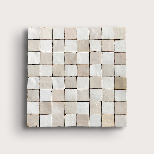 white small square checkerboard zellige tile on a light grey background