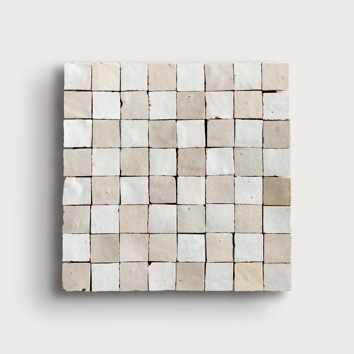 white small square checkerboard zellige tile on a light grey background