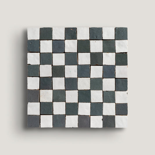 white and grey small square checkerboard zellige tile on a light grey background