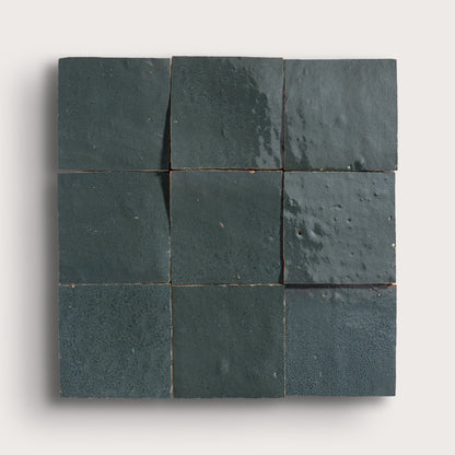 Nine grey zellige square tiles arranged in a 3x3 grid on a white background