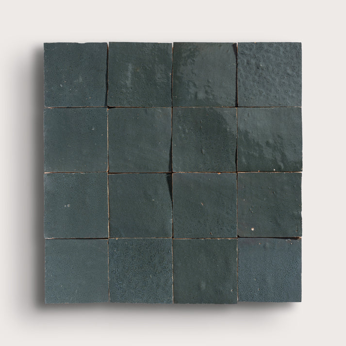 Square arrangement of grey zellige tiles on a white background