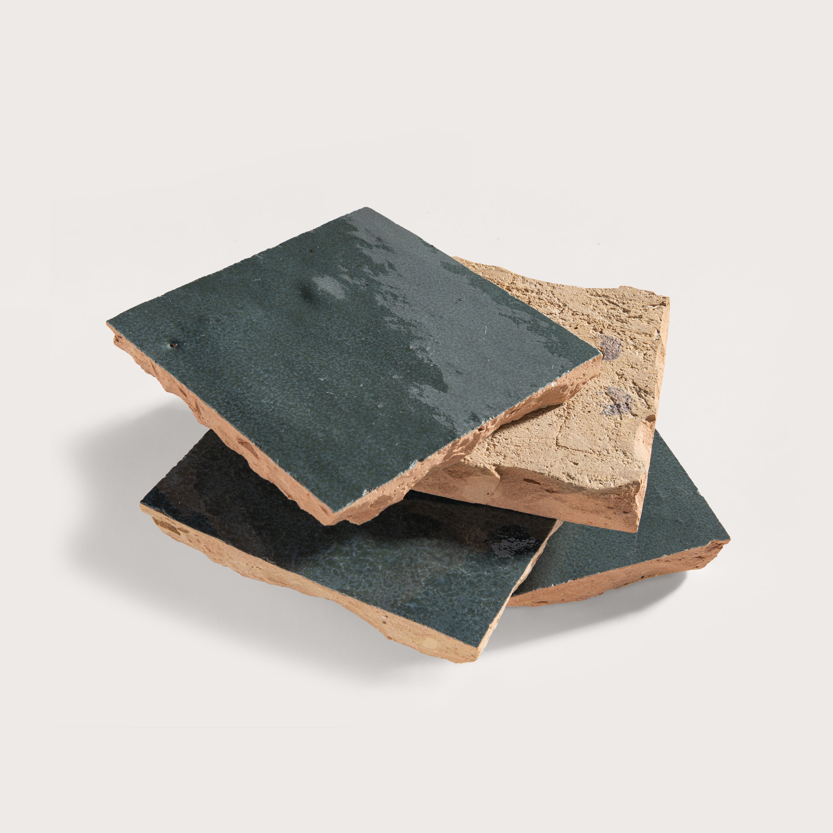 Three stone tiles with different textures on a light gray background