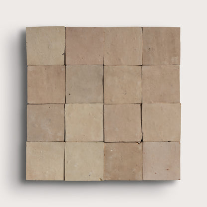 A square arrangement of 12 rustic, square clay tiles in varying shades of beige and light brown, arranged in a 3x4 grid against a light gray background.