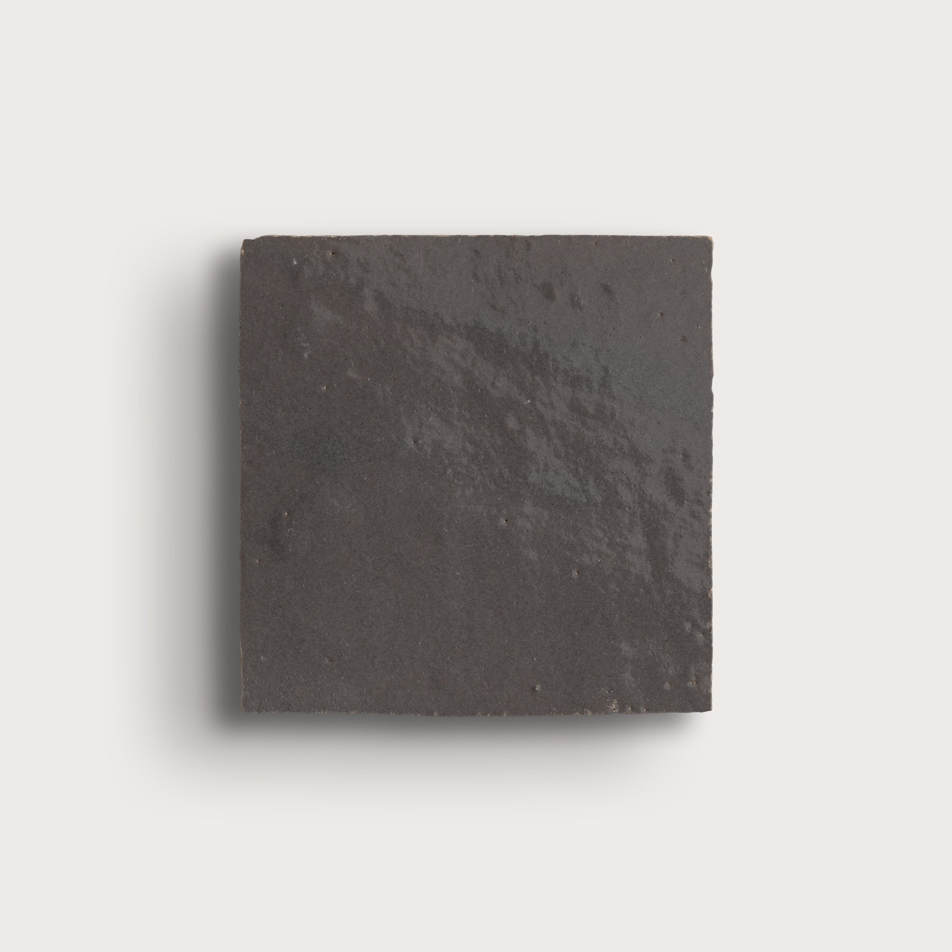 grey square zellige tile on a light gray background