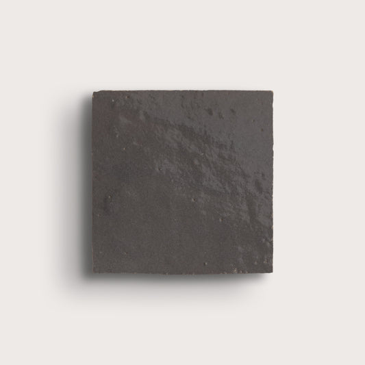 grey square zellige tile on a light gray background