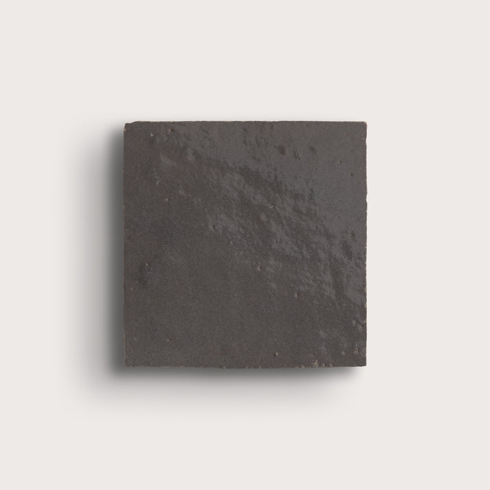 grey square zellige tile on a light gray background