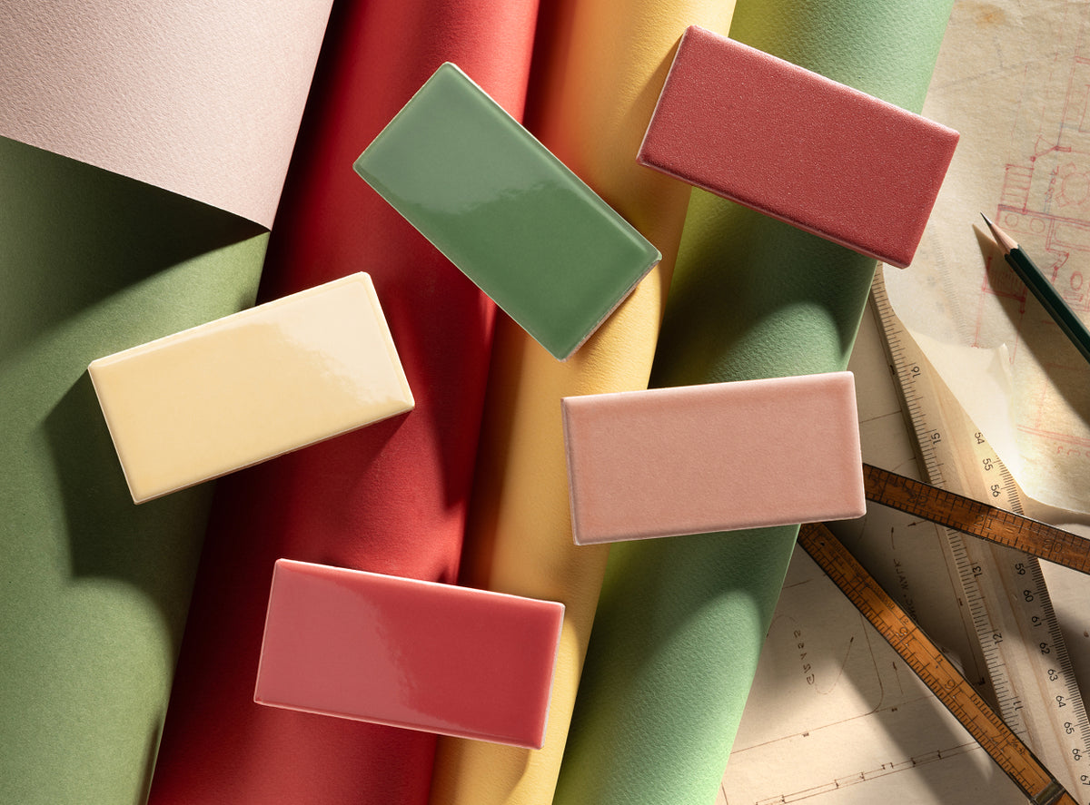 yellow, pink, and green ceramic tiles laid on top of paper in moodboard