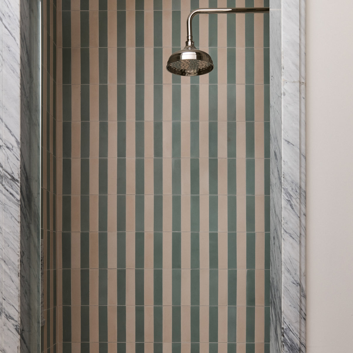 green and white cement striped pattern tile installed on shower wall