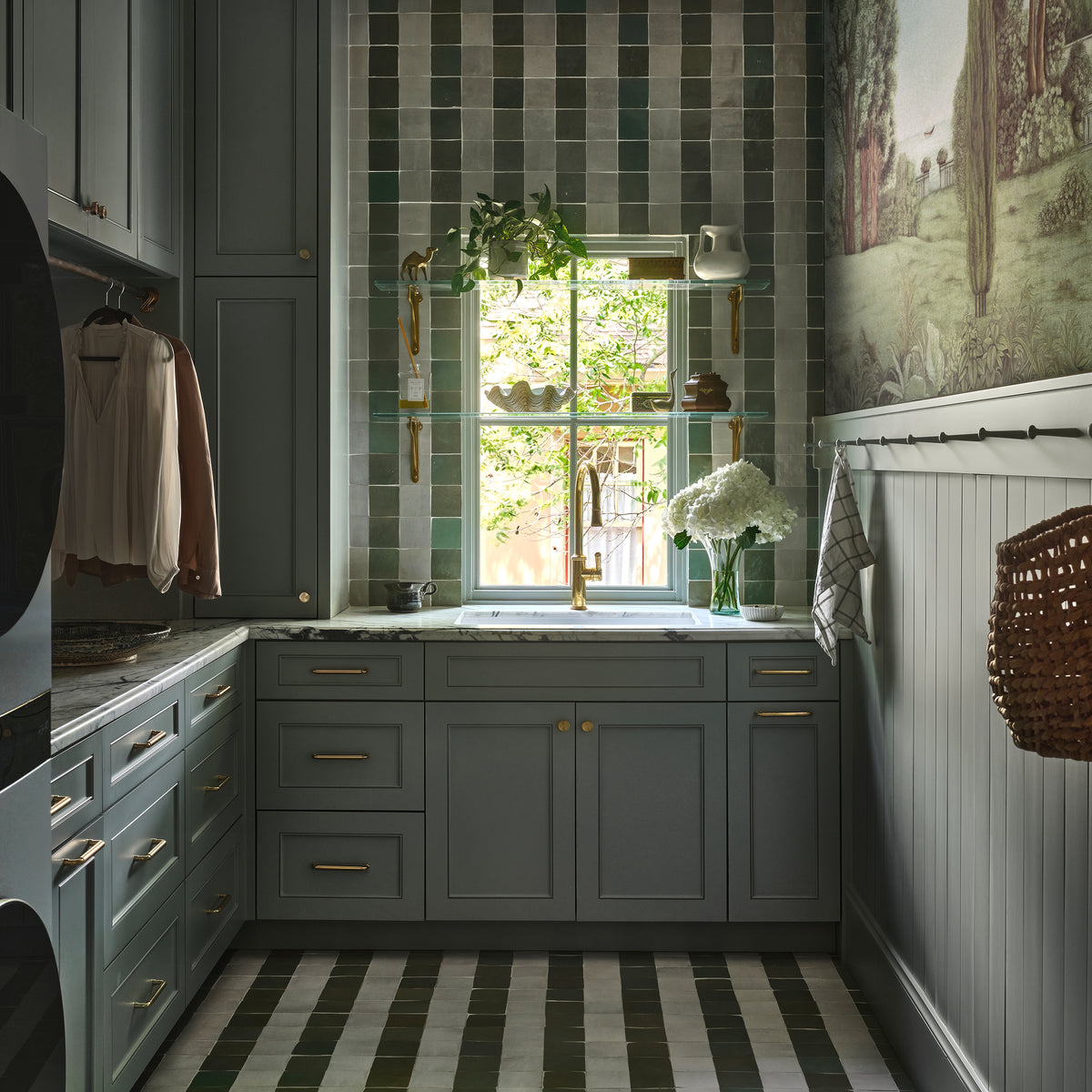 green and white square zellige tile installed in a stripe pattern on the wall and floor in a laundry room