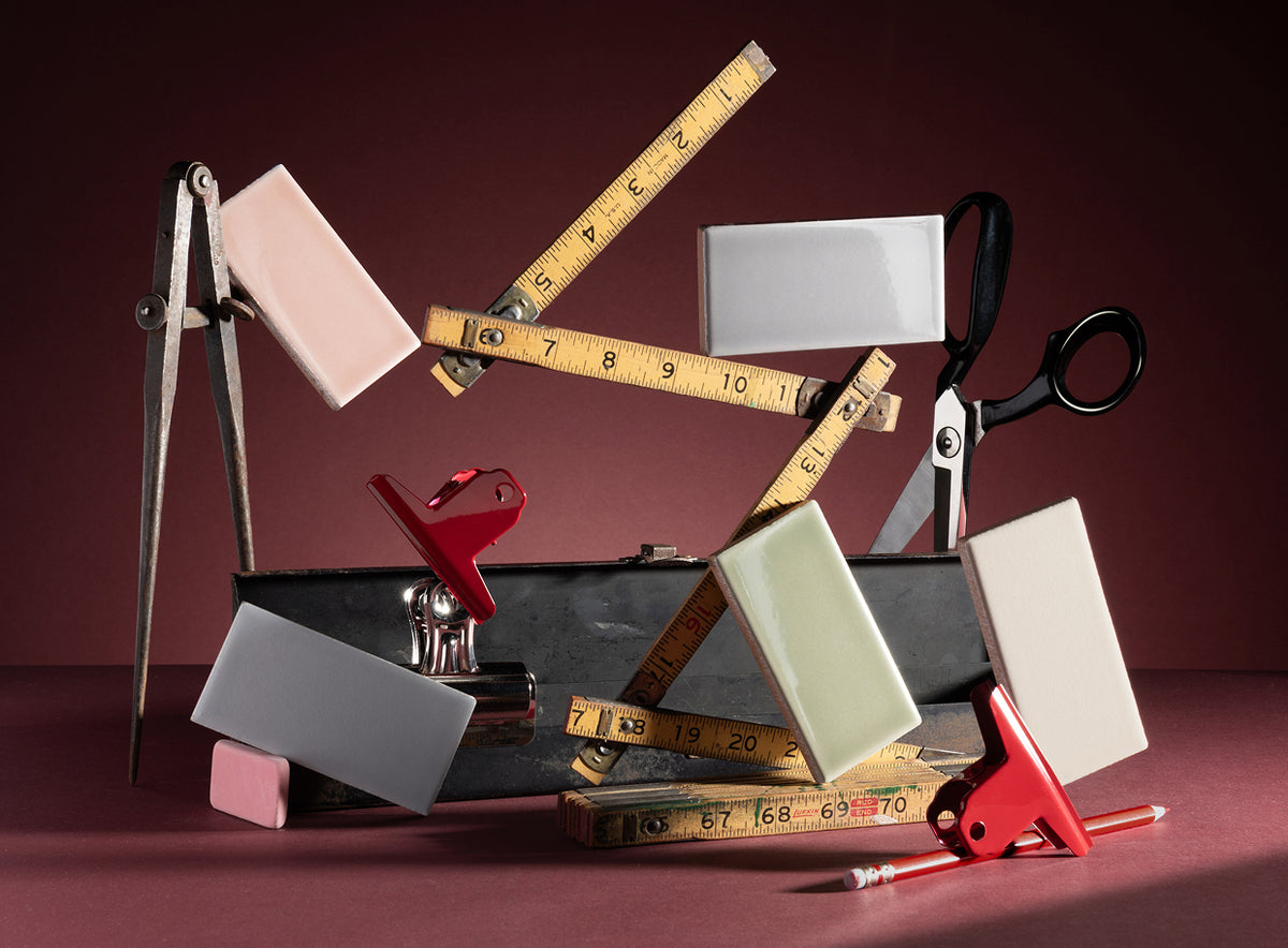 ceramic tiles styled with tape measure, scissors, and other props in lifestyle image
