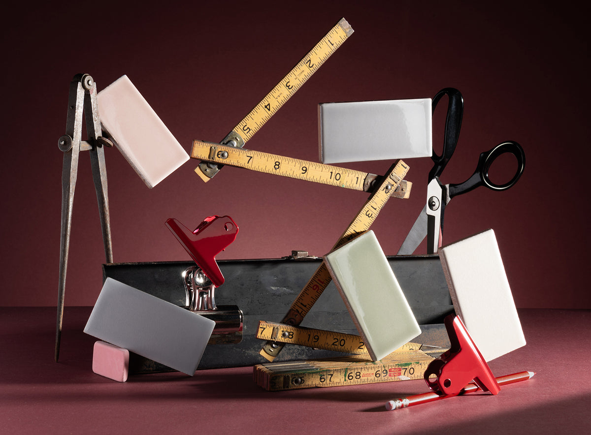 styled ceramic tiles with tape measures, scissors, pencils, and clips