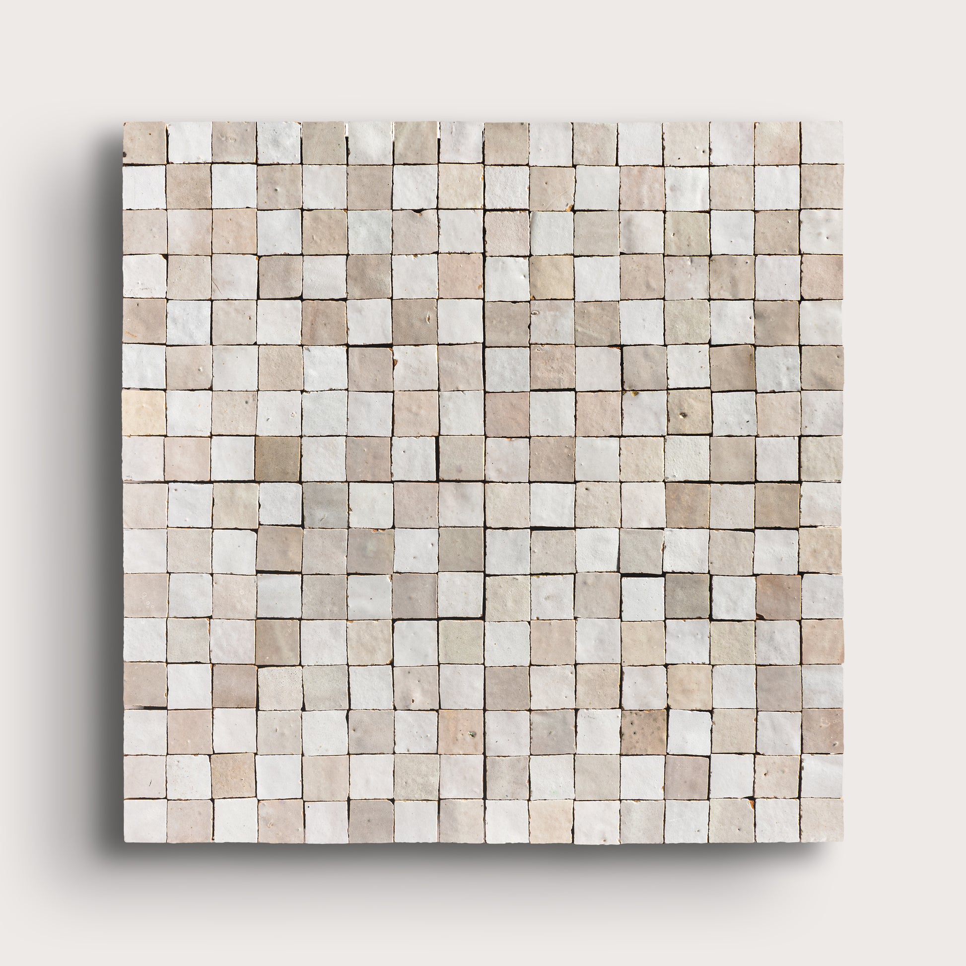 white small square checkerboard zellige tile on a light grey background