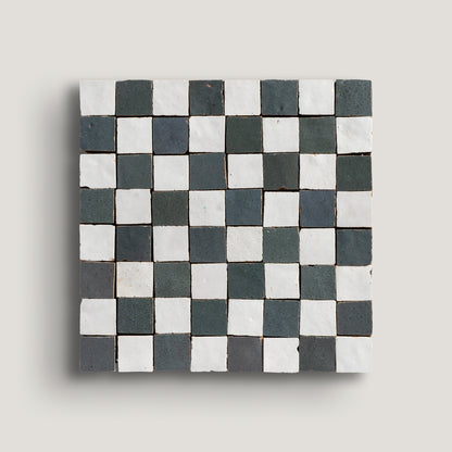 white and grey small square checkerboard zellige tile on a light grey background