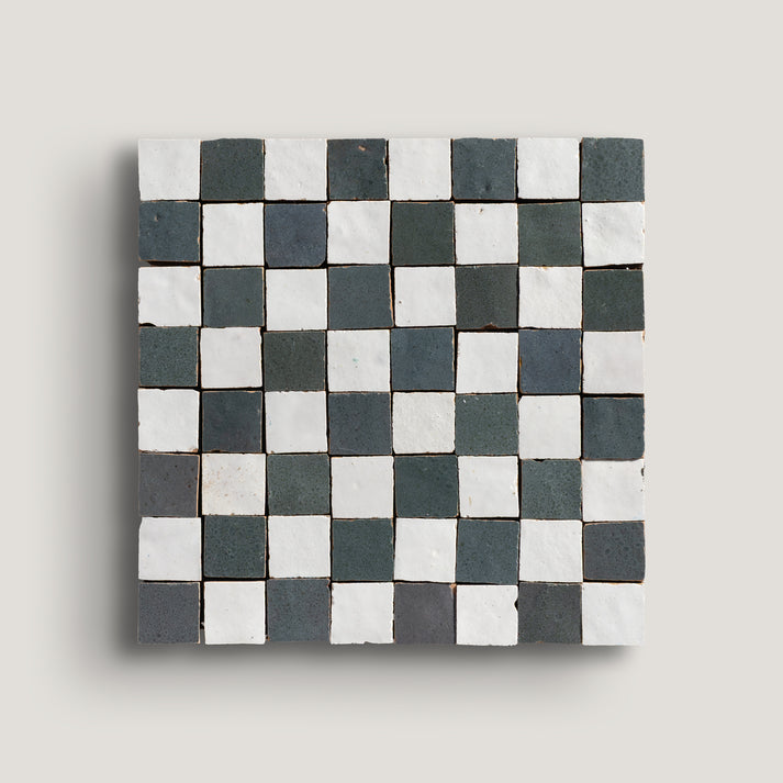 white and grey small square checkerboard zellige tile on a light grey background