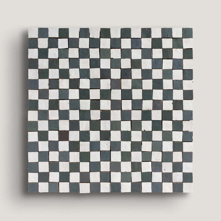 white and grey small square checkerboard zellige tile on a light grey background