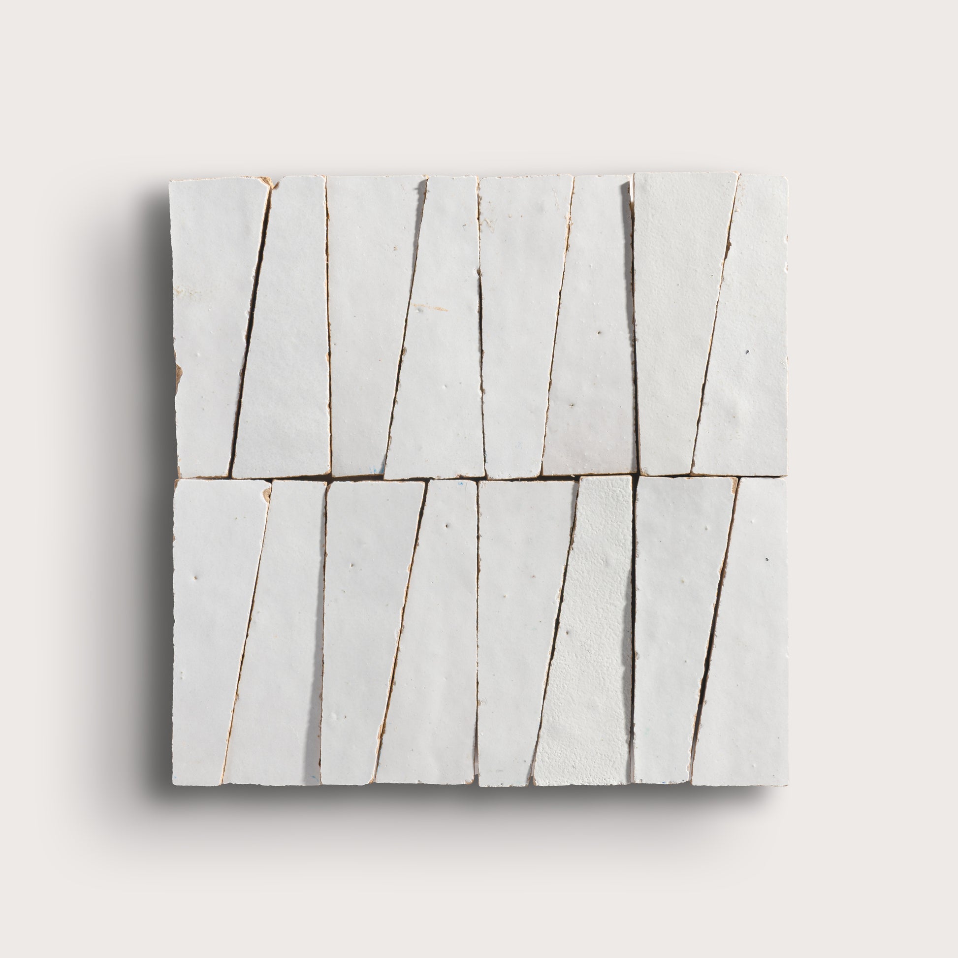 snow white trapezoid zellige tile on a light grey background