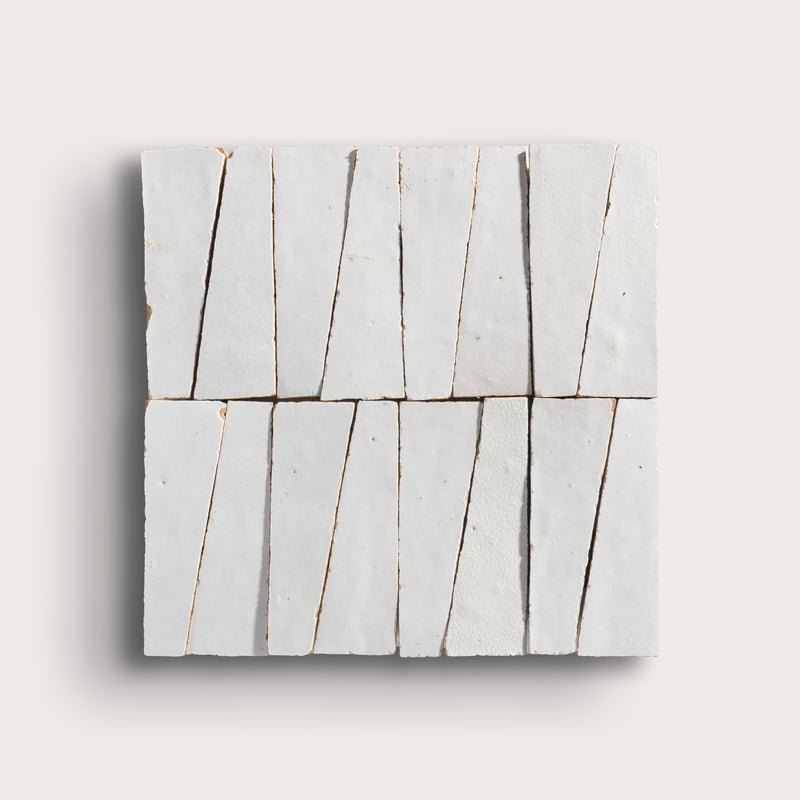 snow white trapezoid zellige tile on a light grey background