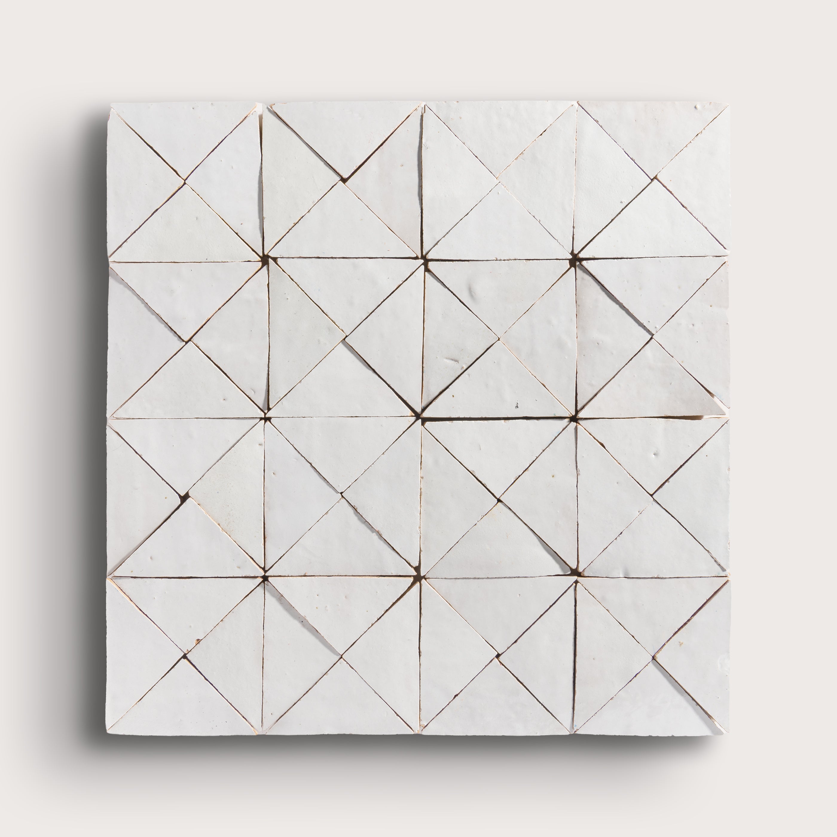 snow white mosaic traingle zellige tile on a light grey background