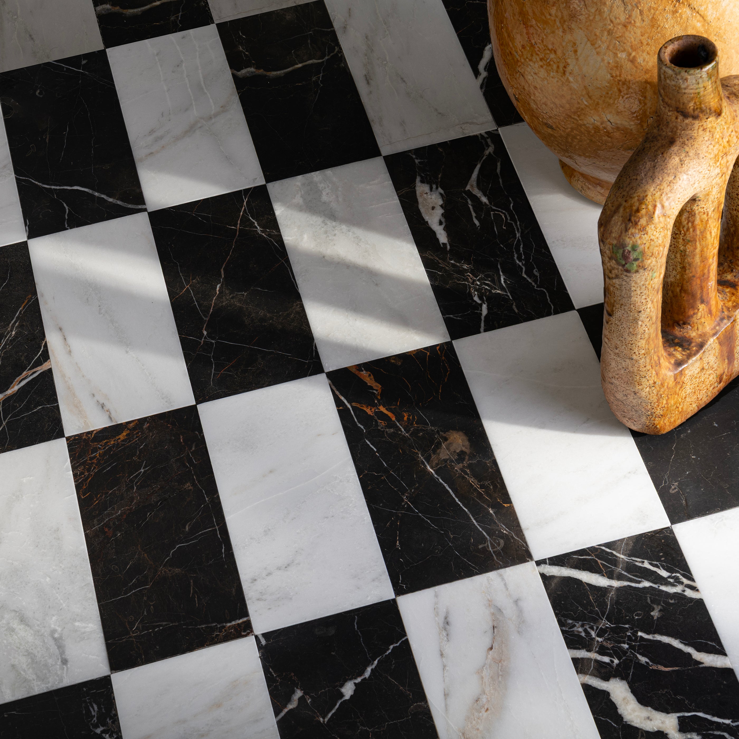 Checkered black and white marble floor with rustic ceramic pots.