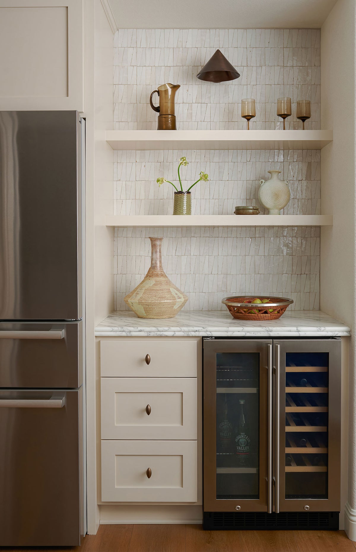 white trapezoid zellige tile installed as backsplash in kitchen