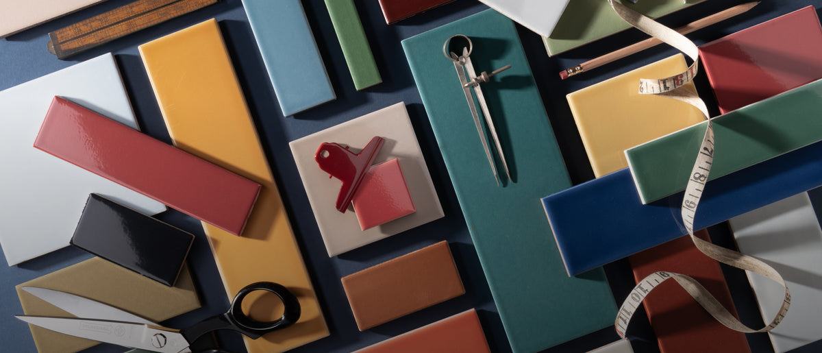 multi color ceramic tile styled in flat lay with tape measure, scissors, and clips