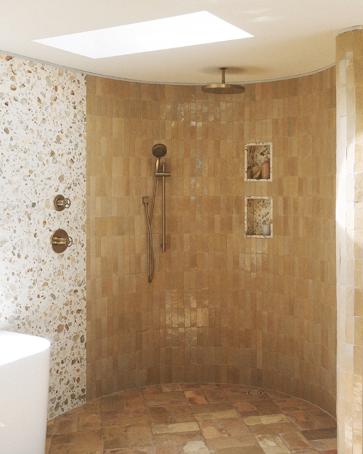 Feel that? Set the mood, then build the room. Warm tones, tactile surfaces and a little shine take it from feeling to fully realized.

Tile: Glazed Clay 2x6 Thin Bejmat Zellige Tile, Rolling Stone 24x24 Venezia Terrazzo Tile
Design/Photo: @villastino