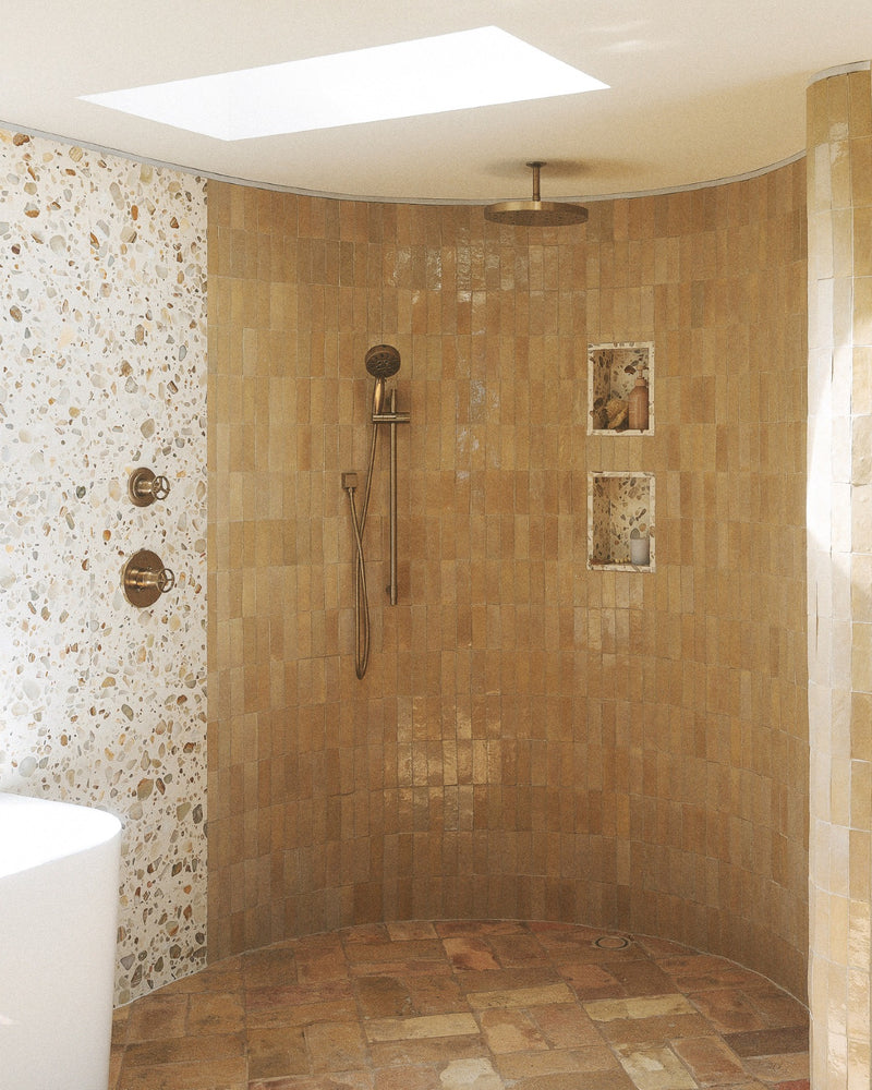 Feel that? Set the mood, then build the room. Warm tones, tactile surfaces and a little shine take it from feeling to fully realized.

Tile: Glazed Clay 2x6 Thin Bejmat Zellige Tile, Rolling Stone 24x24 Venezia Terrazzo Tile
Design/Photo: @villastino