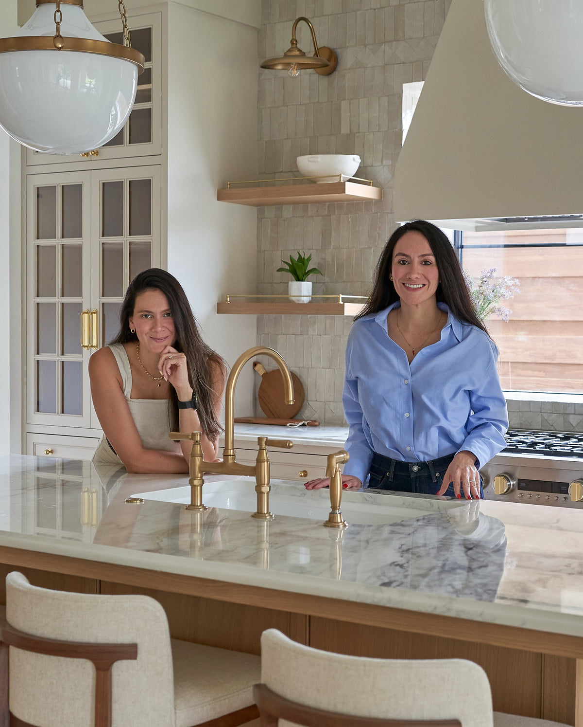 two interior designers standing in kitchen