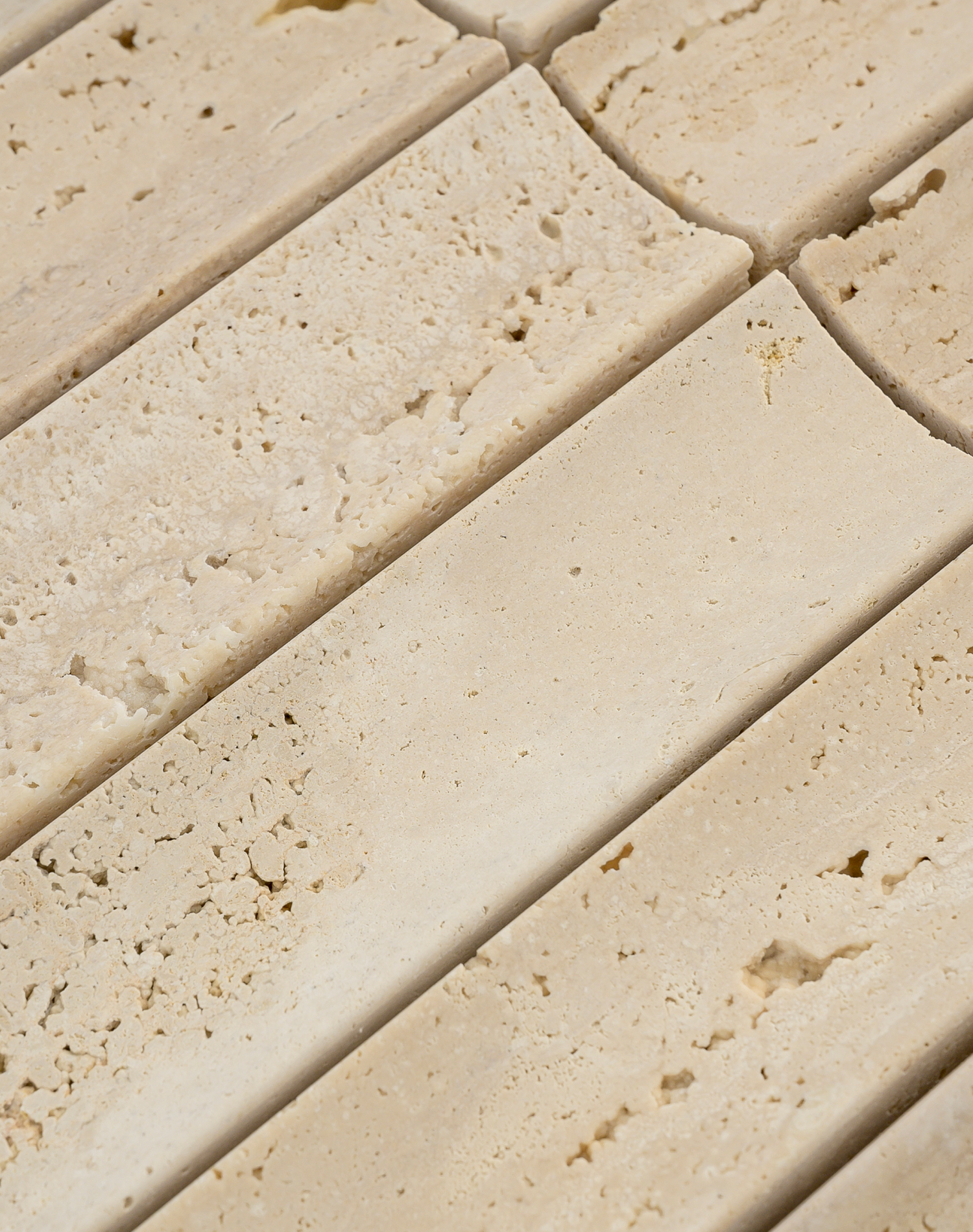 Close-up of beige travertine tiles arranged in a pattern
