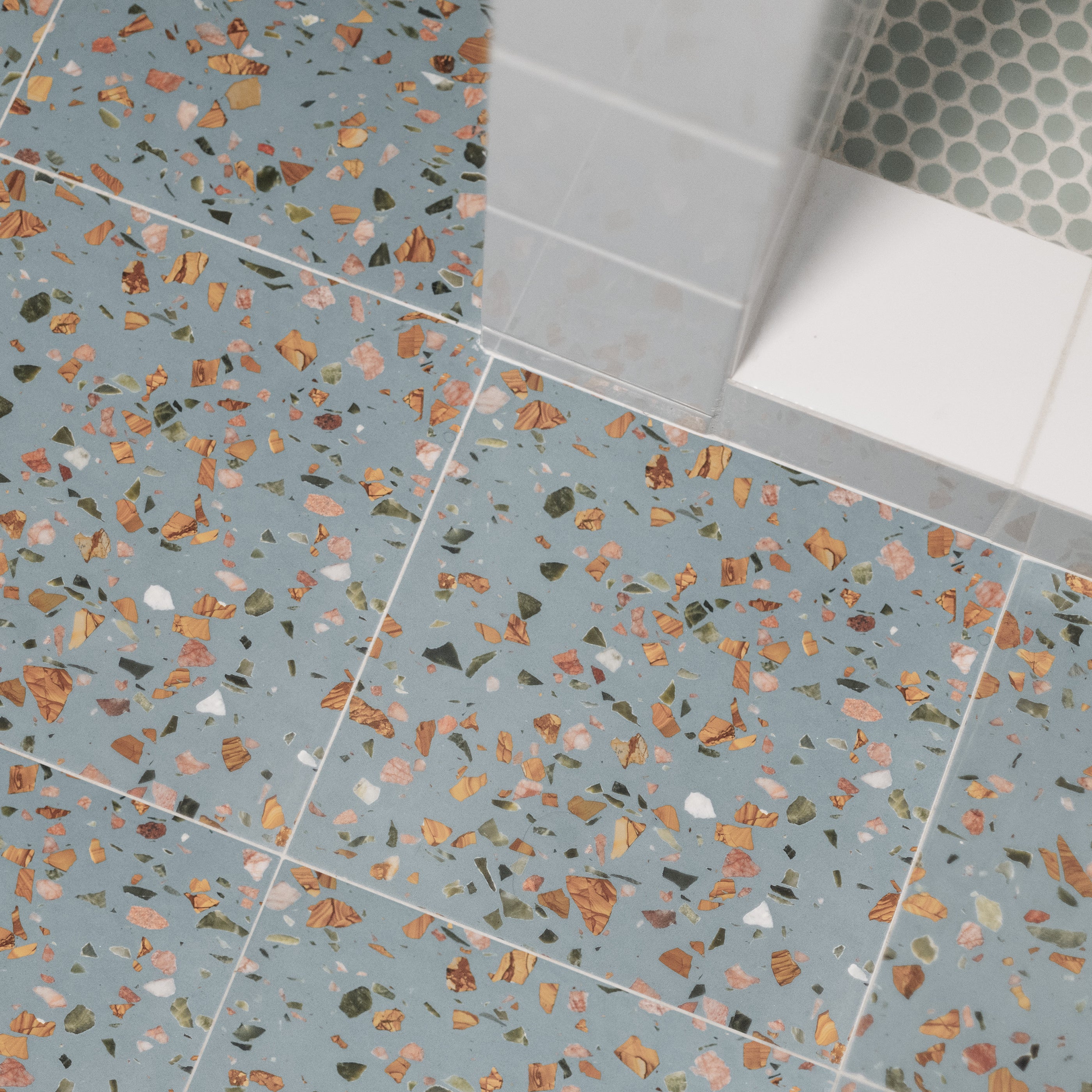 Blue terrazzo tile installed on floor in bathroom